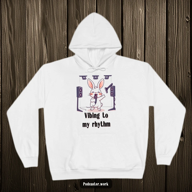 Funny hoodie featuring a hyperactive rabbit energetically bouncing with a microphone in a studio, offering cozy and humorous warmth.